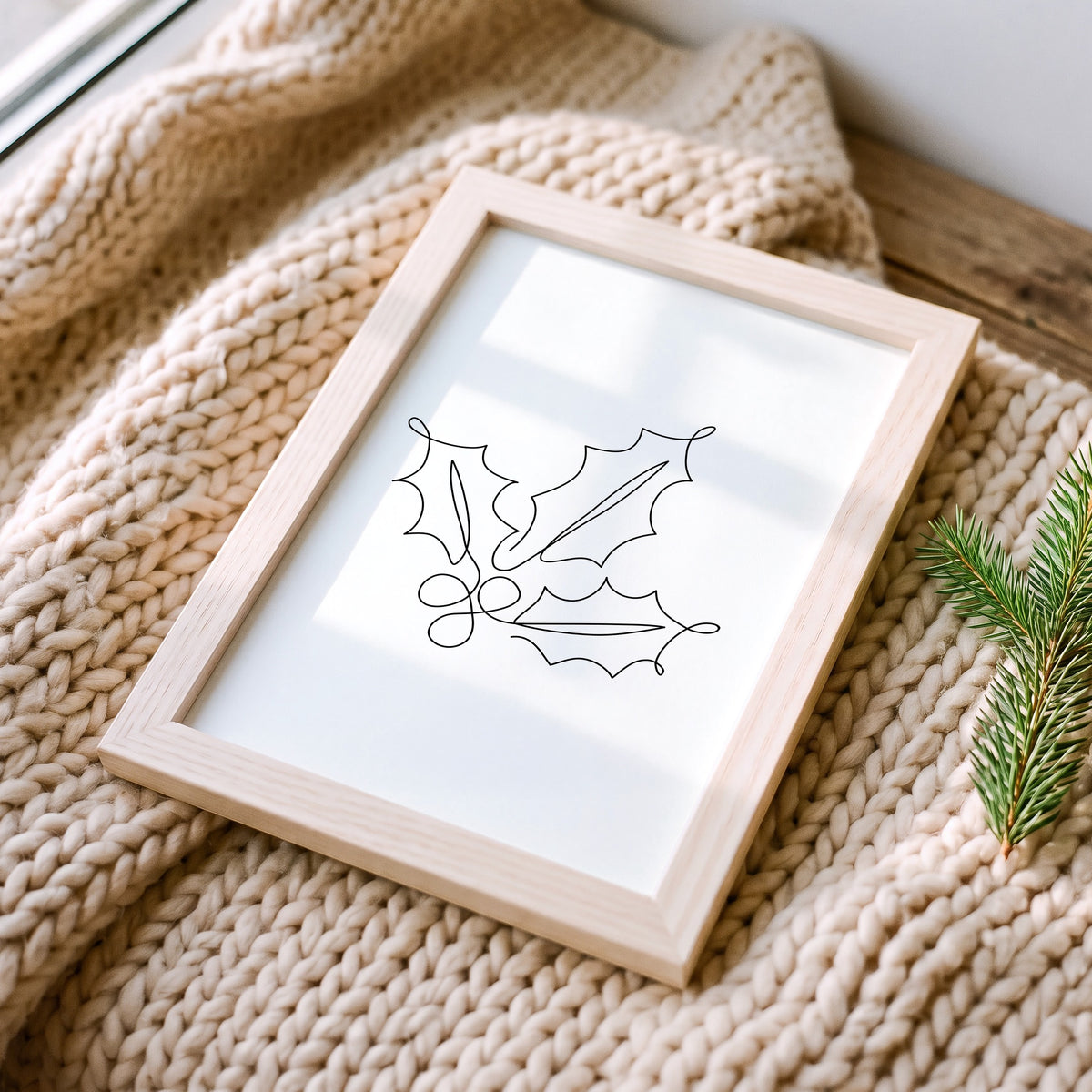 Weihnachtsposter One Line im Holzrahmen auf einer Strickdecke