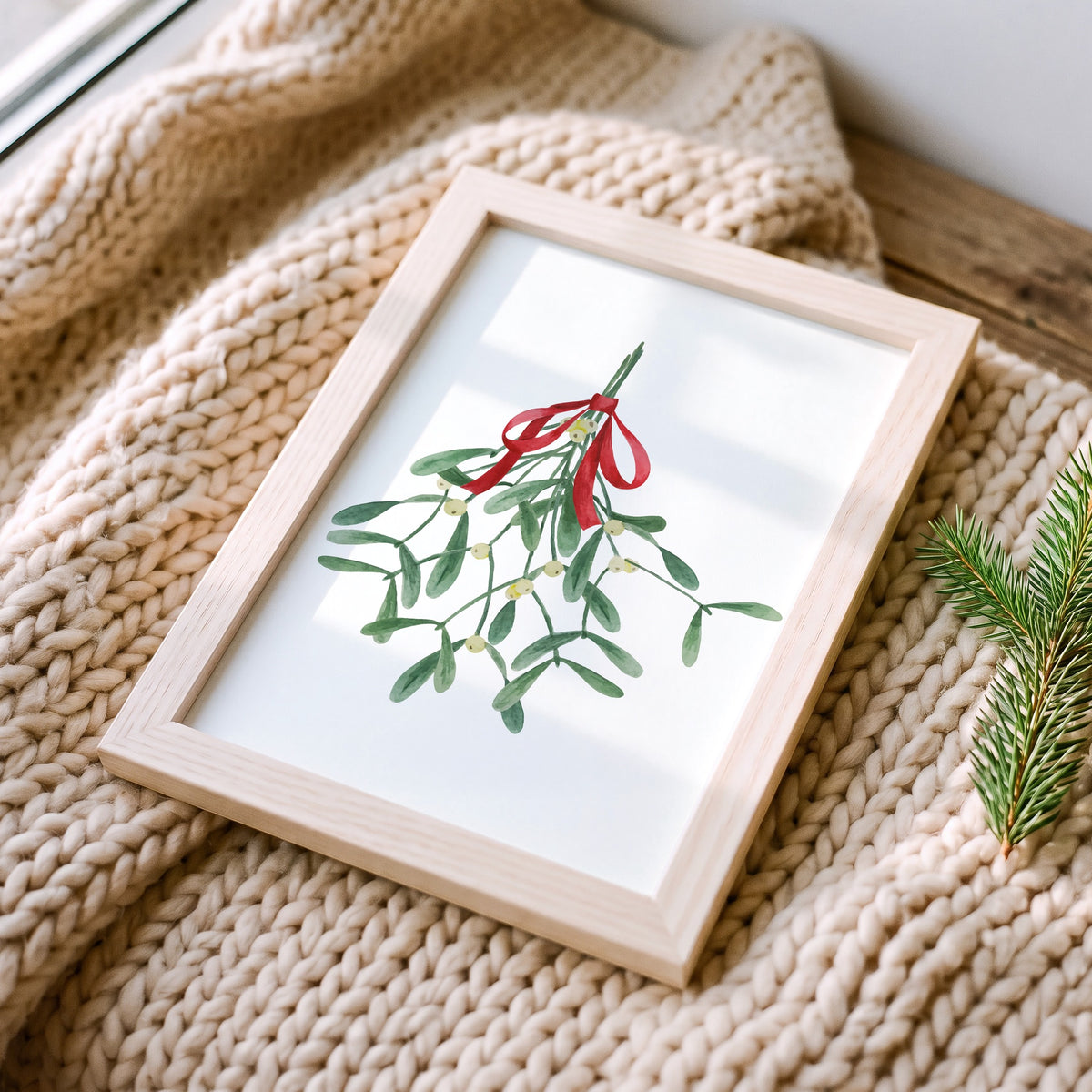 Weihnachtsposter Mistletoe im Holzrahmen auf einer Strickdecke