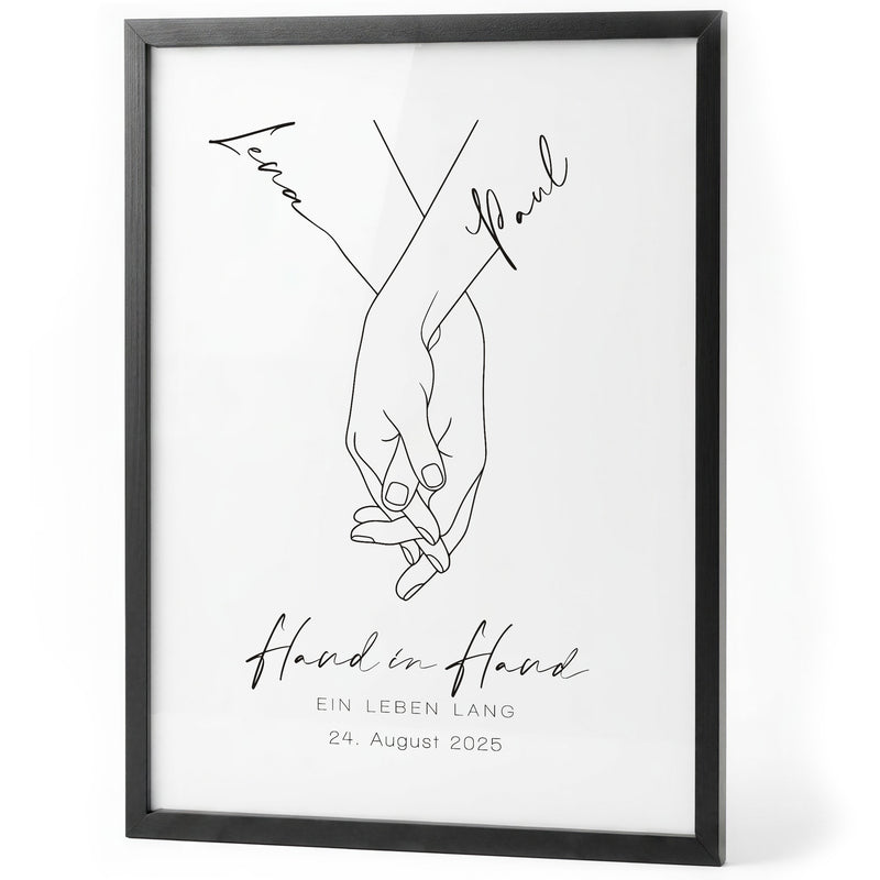 Weißes Hand-in-Hand-Poster mit Lena und Paul im schwarzen Holzrahmen auf weißem Hintergrund
