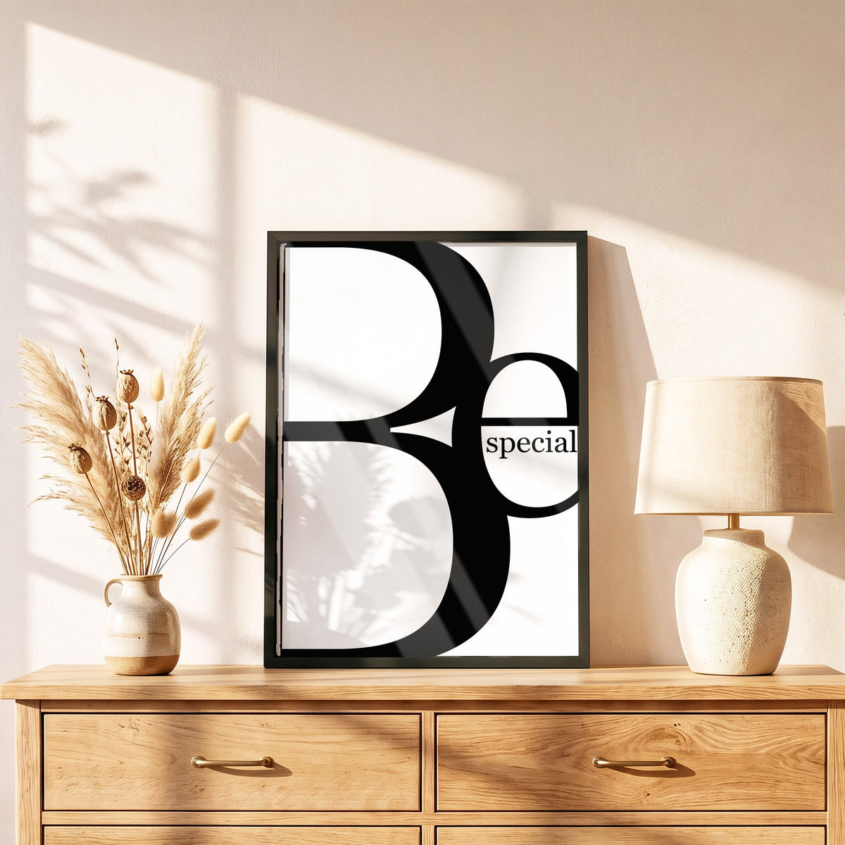 Poster Be Special im schwarzen Holzrahmen auf einer Kommode