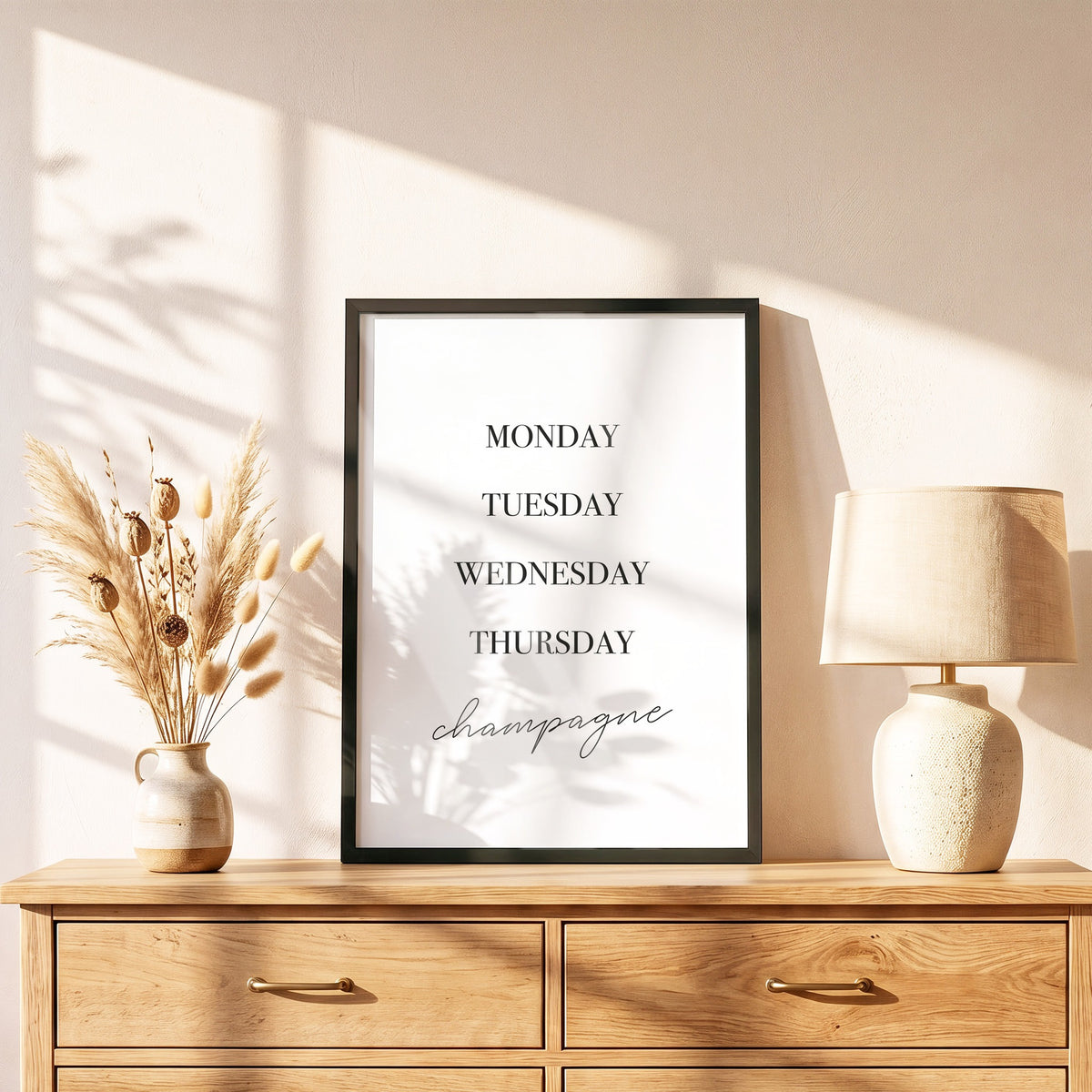 Poster Champagne im schwarzen Holzrahmen auf einer Kommode