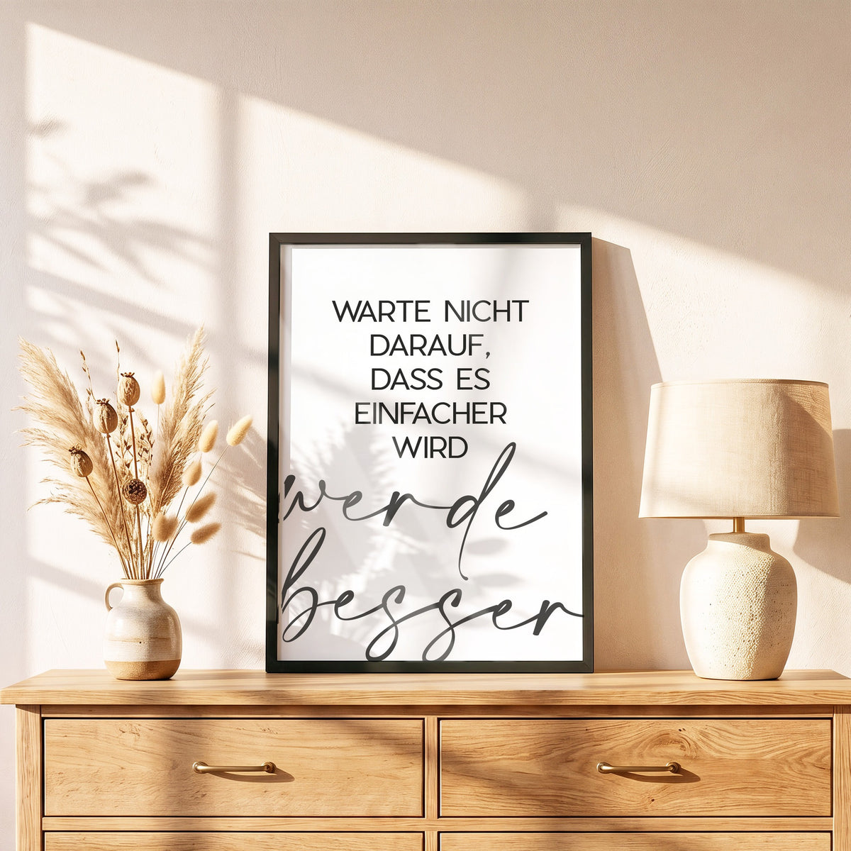 Poster Werde besser im schwarzen Holzrahmen auf einer Kommode